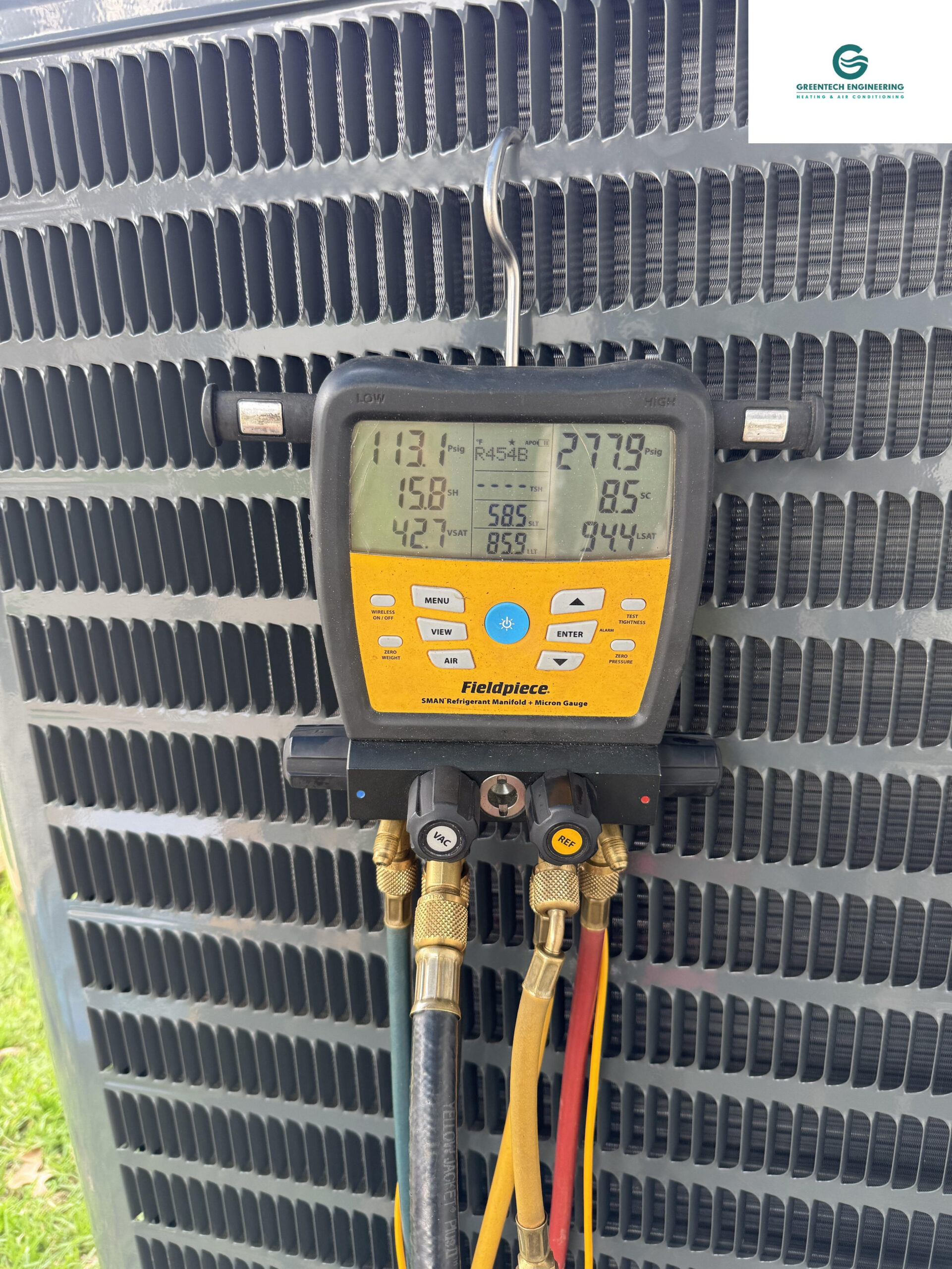 Greentech Engineering utilizing a digital Fieldpiece manifold to verify exact refrigerant pressures and subcooling on a new AC unit.