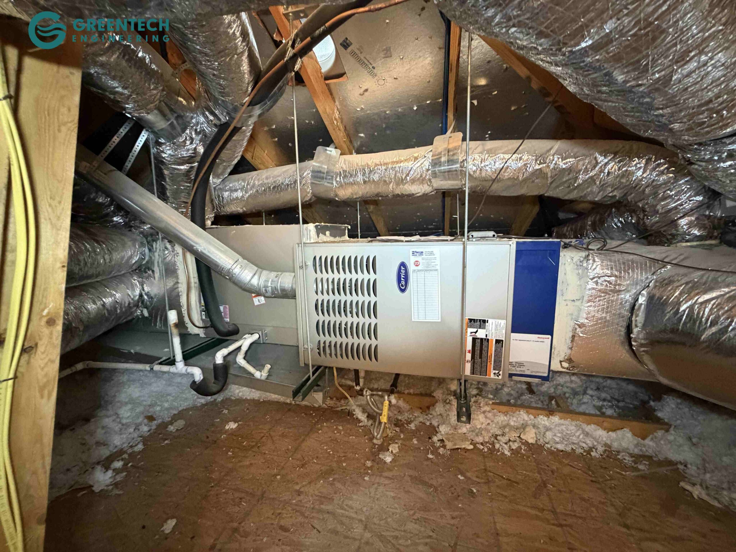 An old, horizontal furnace and evaporator coil installed in a Dallas residential attic with poor duct sealing and restrictive airflow.