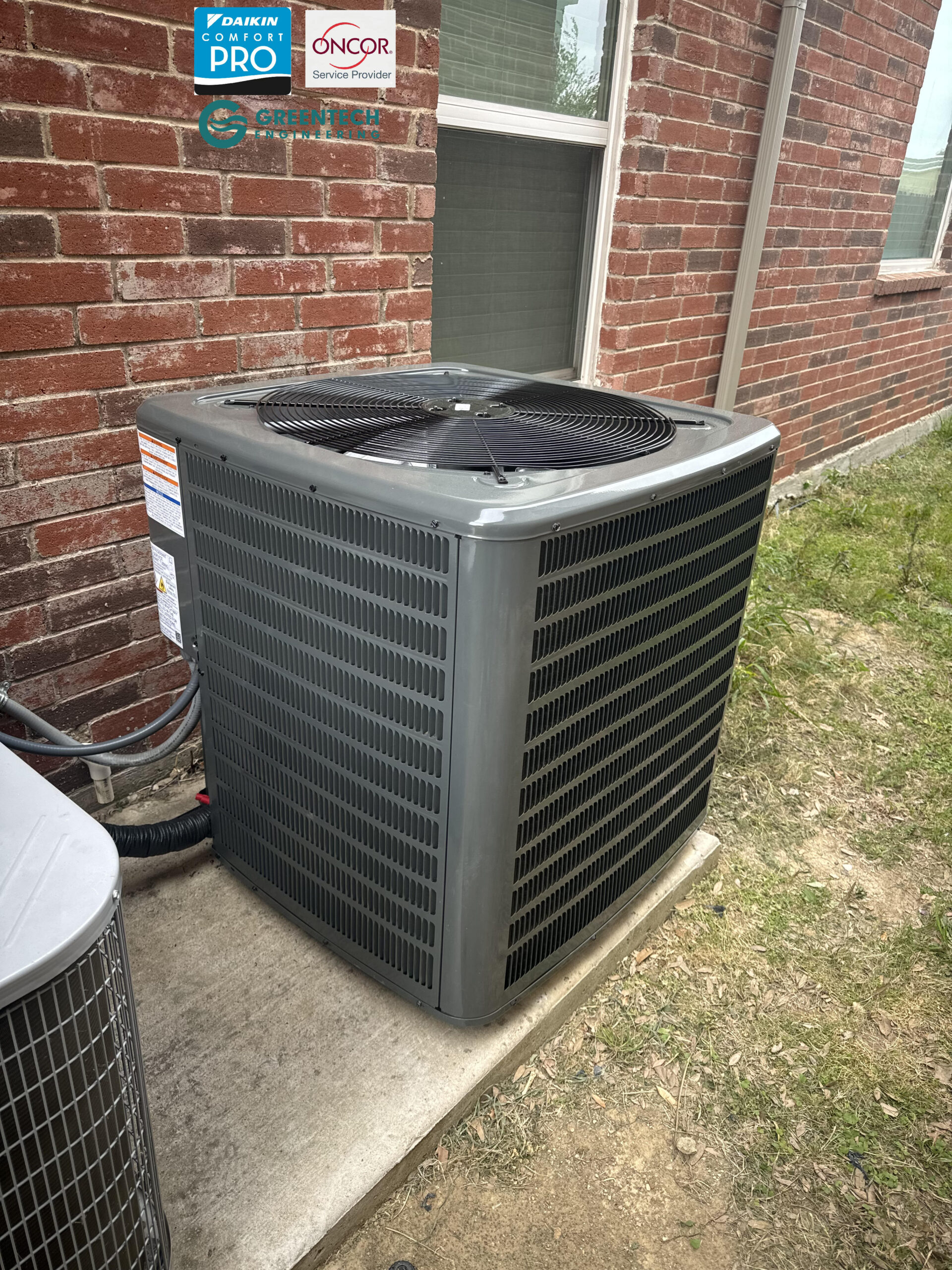 A newly installed, high-efficiency 4-Ton Goodman heat pump condenser sitting perfectly level on a concrete pad by Greentech Engineering in Fort Worth, TX.
