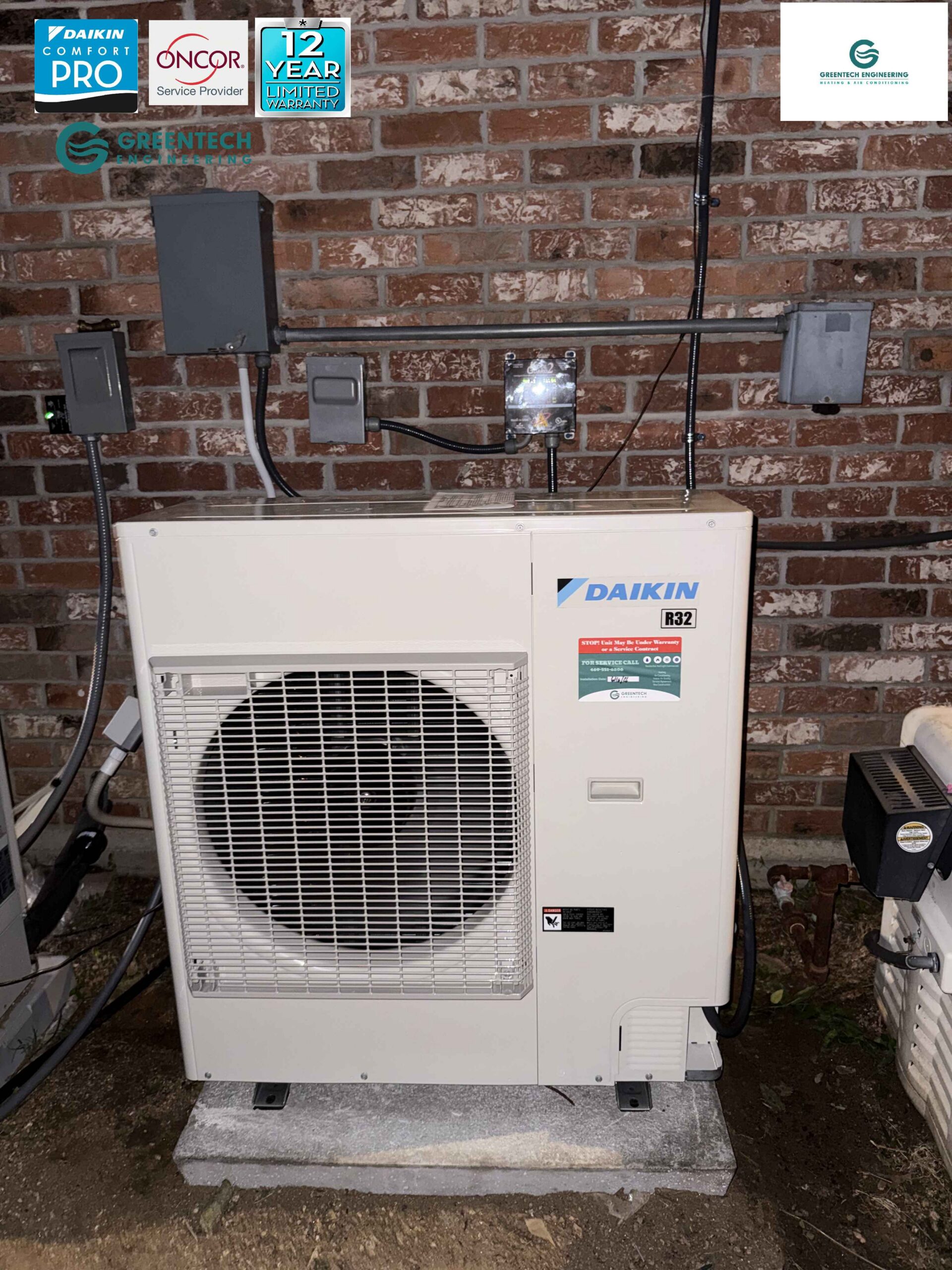 A pristine Daikin FIT variable-speed side-discharge condenser installed on a leveled concrete pad in Dallas, TX, featuring a dedicated voltage surge protector on the brick wall.