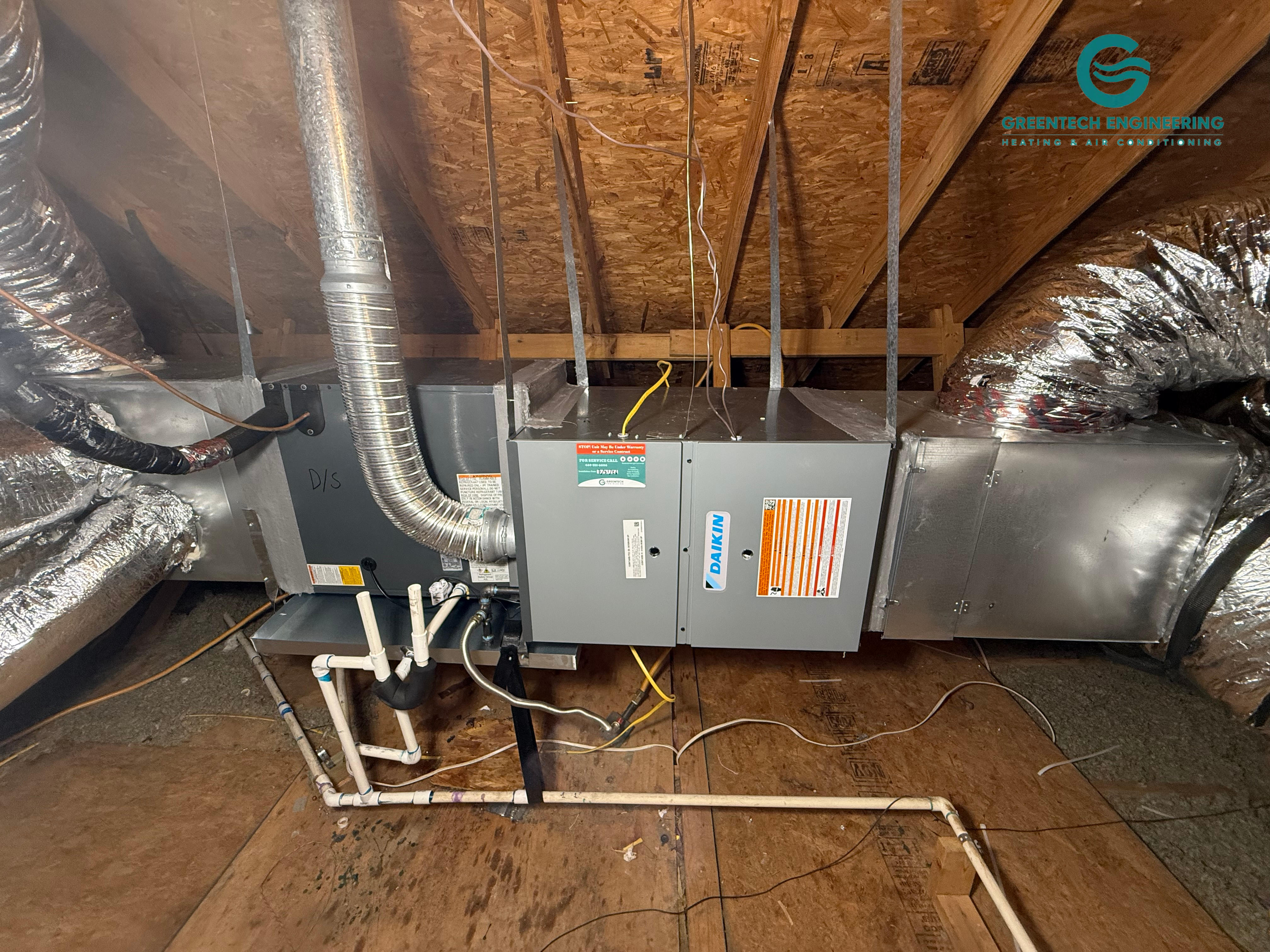 Horizontal Daikin indoor HVAC equipment with connected plenum and return ductwork in a Grand Prairie attic