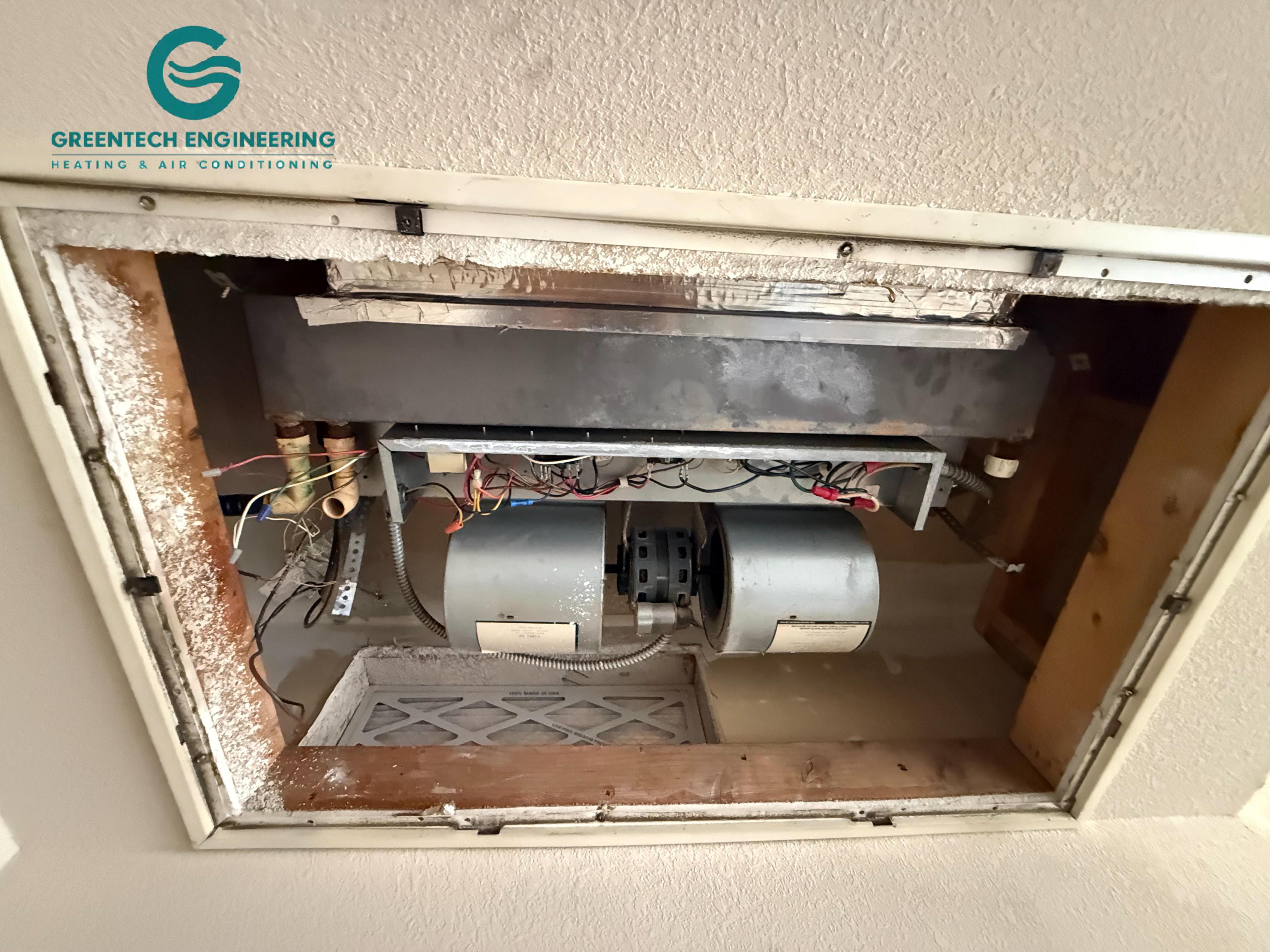 Existing ceiling-mounted HVAC unit before an Irving heat-pump conversion