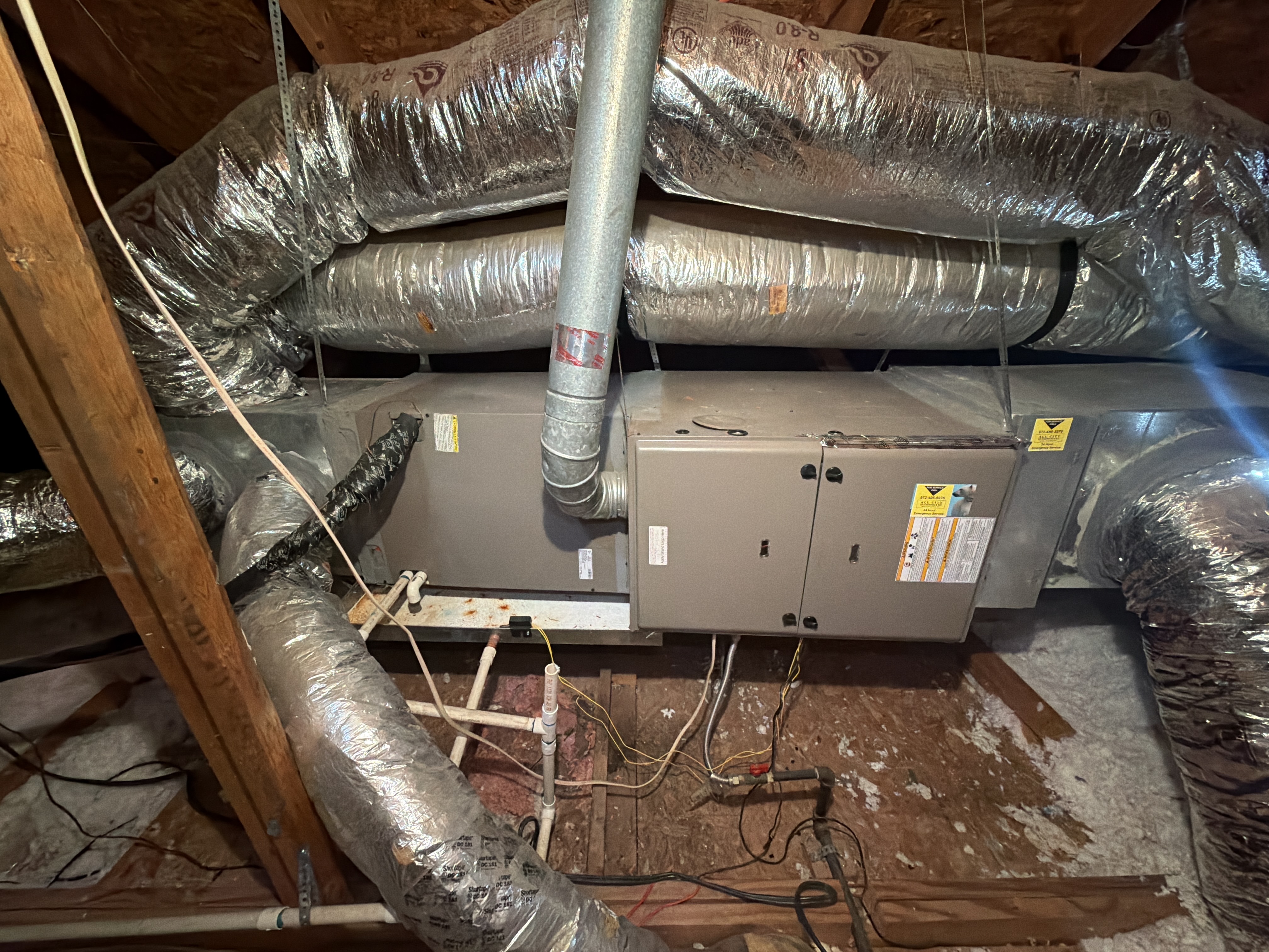 Older upstairs horizontal HVAC equipment in a Plano attic before replacement