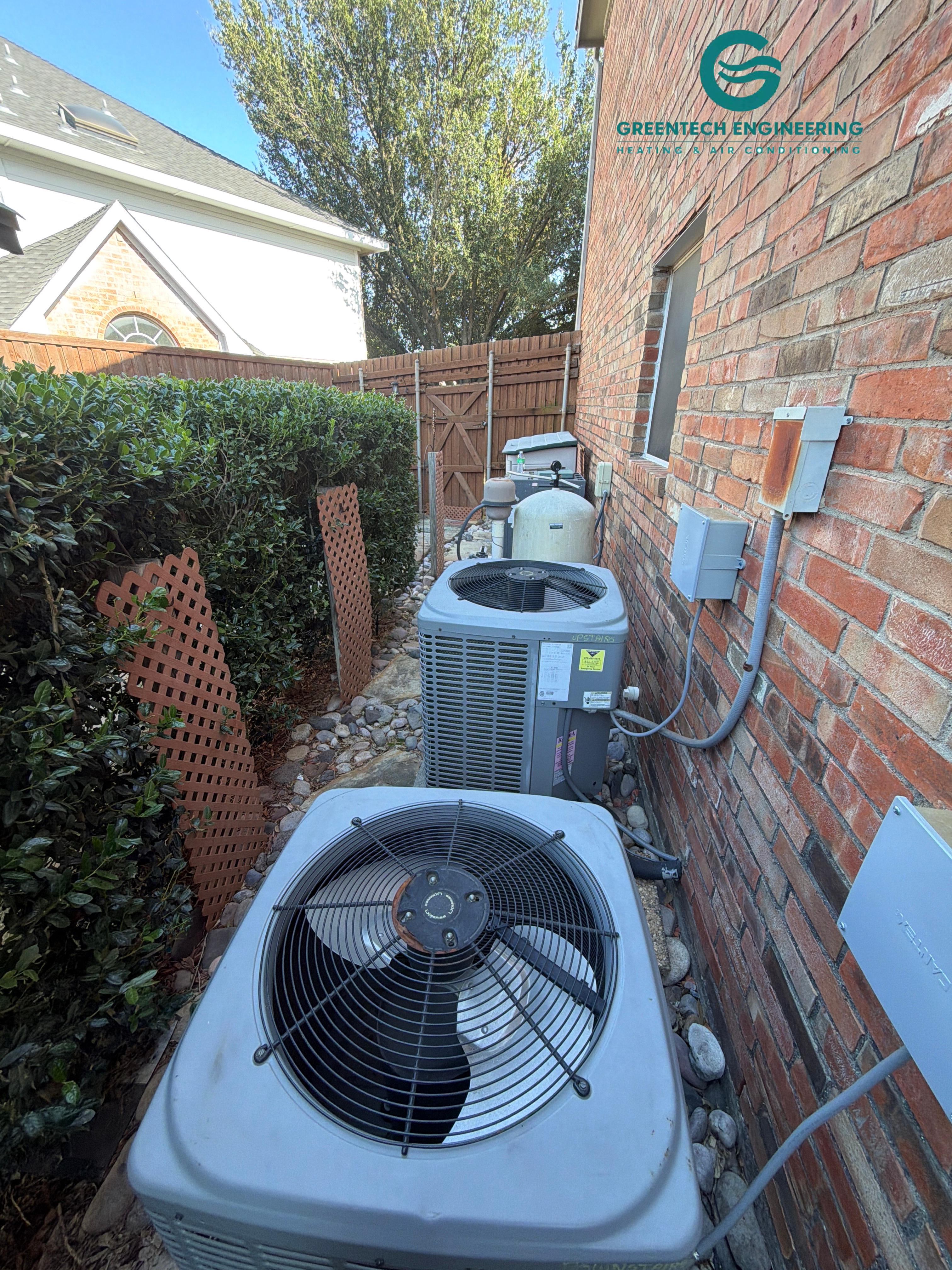Two older outdoor AC condensers before replacement at a Plano home