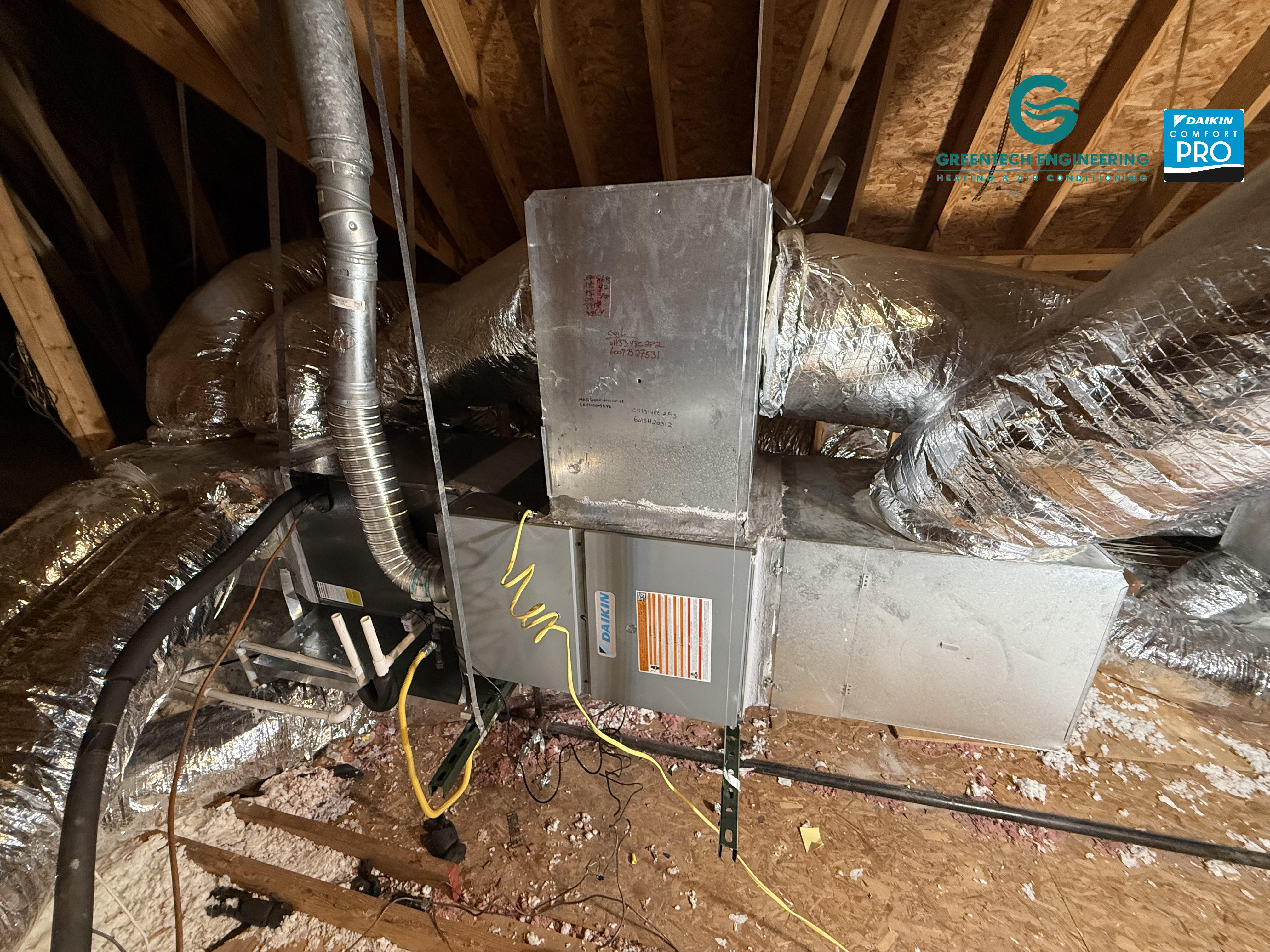 Horizontal Daikin gas furnace and evaporator coil being installed in a Dallas attic