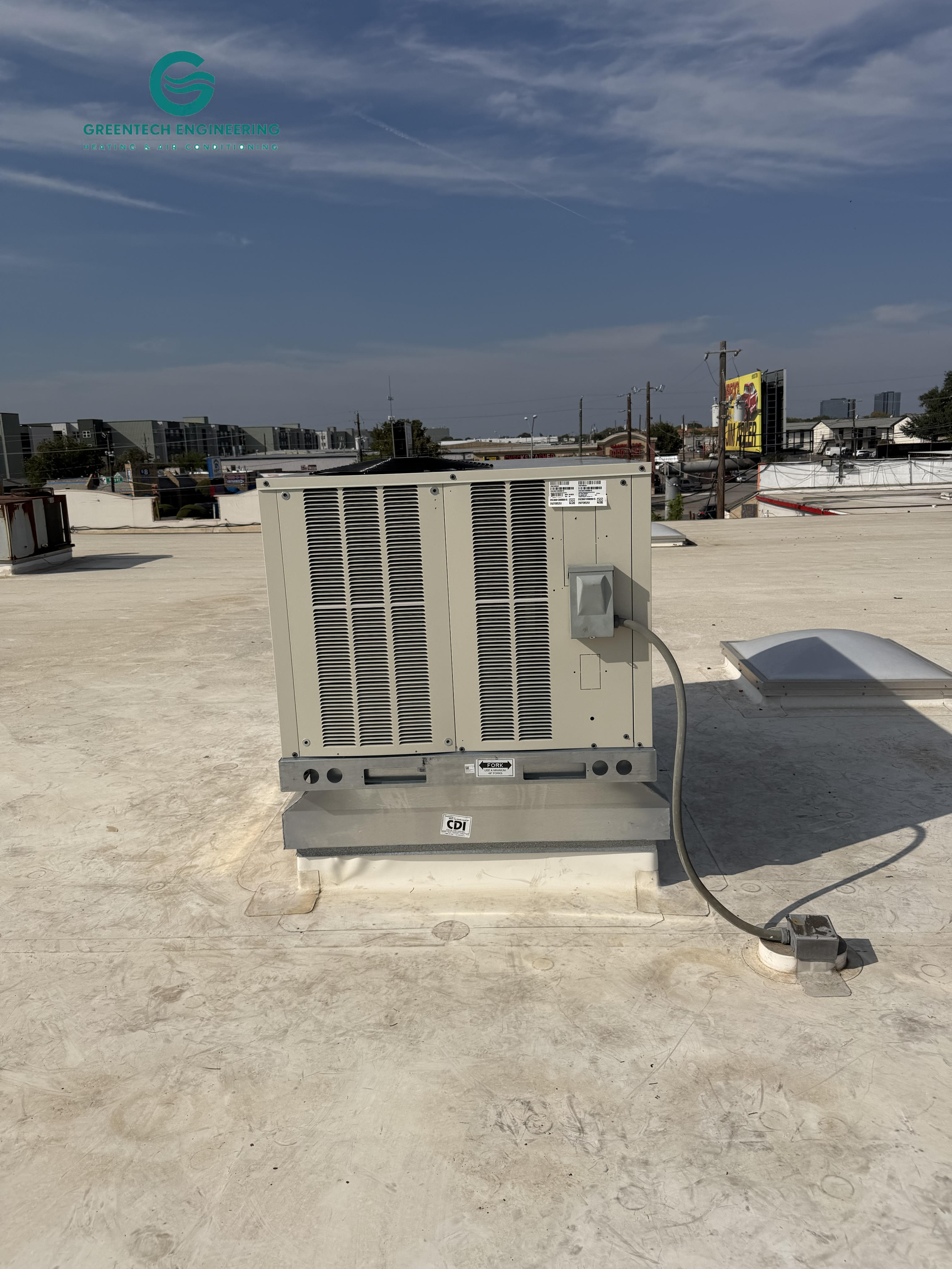 Commercial Daikin rooftop unit mounted on a custom curb adapter in Dallas 75229