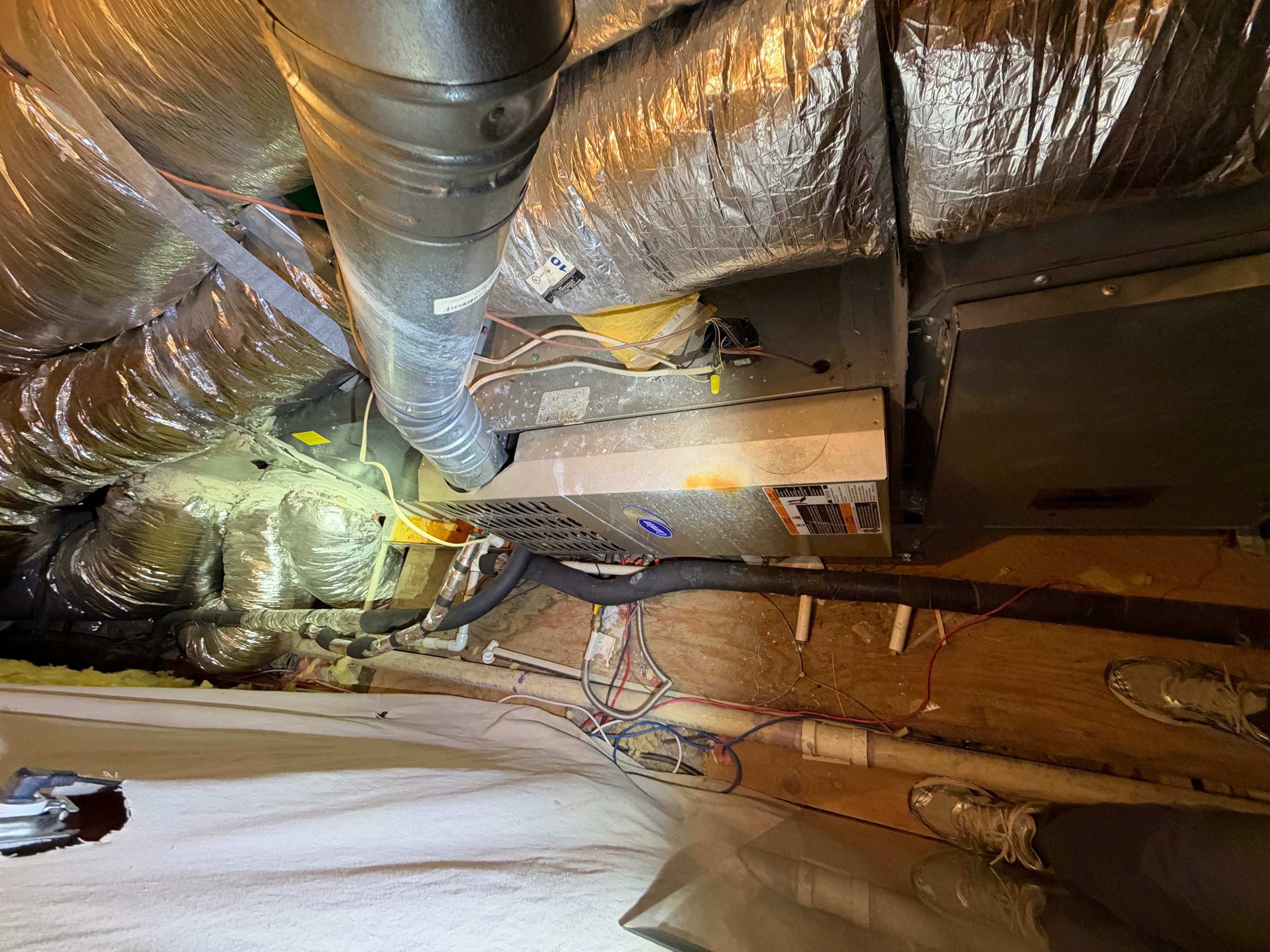 Existing horizontal attic HVAC equipment before a Highland Park replacement