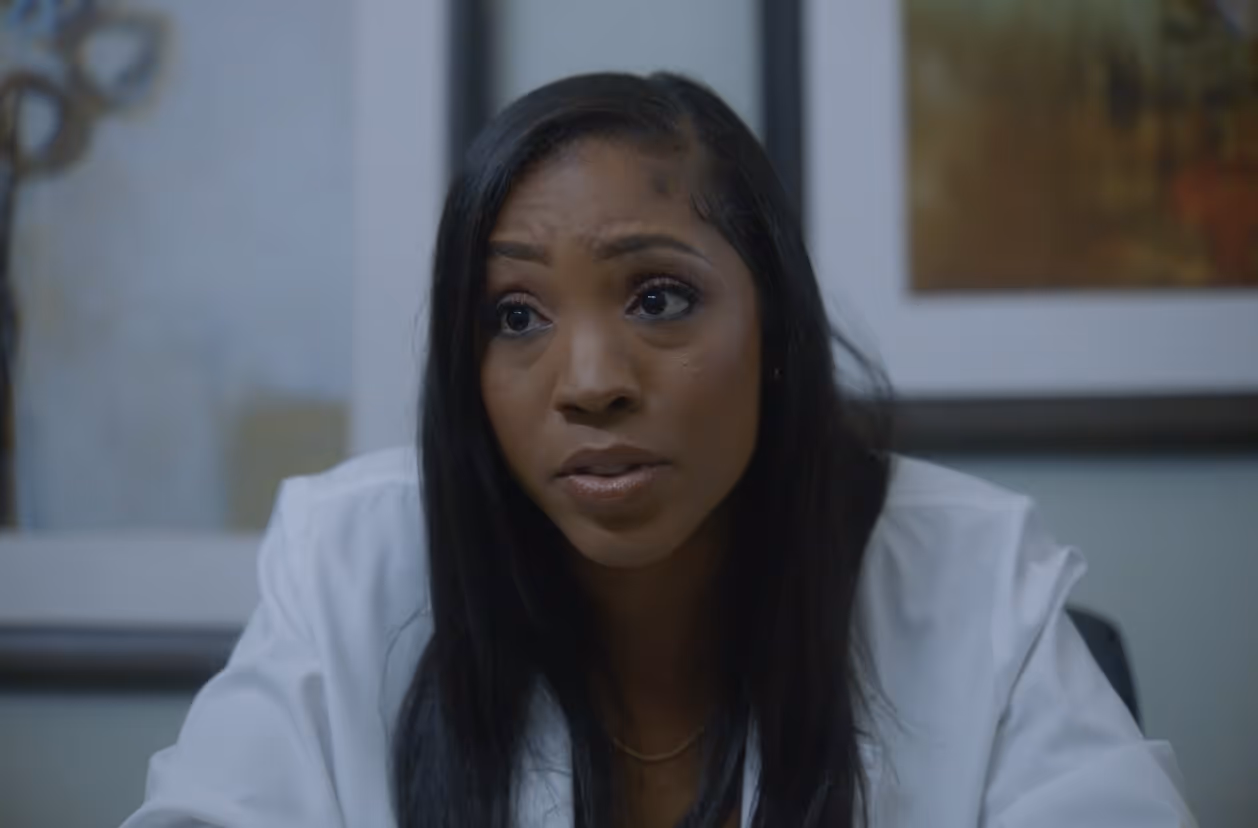 Professional portrait of a female doctor or healthcare provider with a serious expression.
