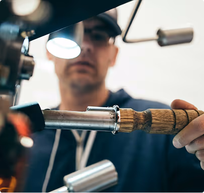 Craftsman using metal tool with wooden handle in workshop