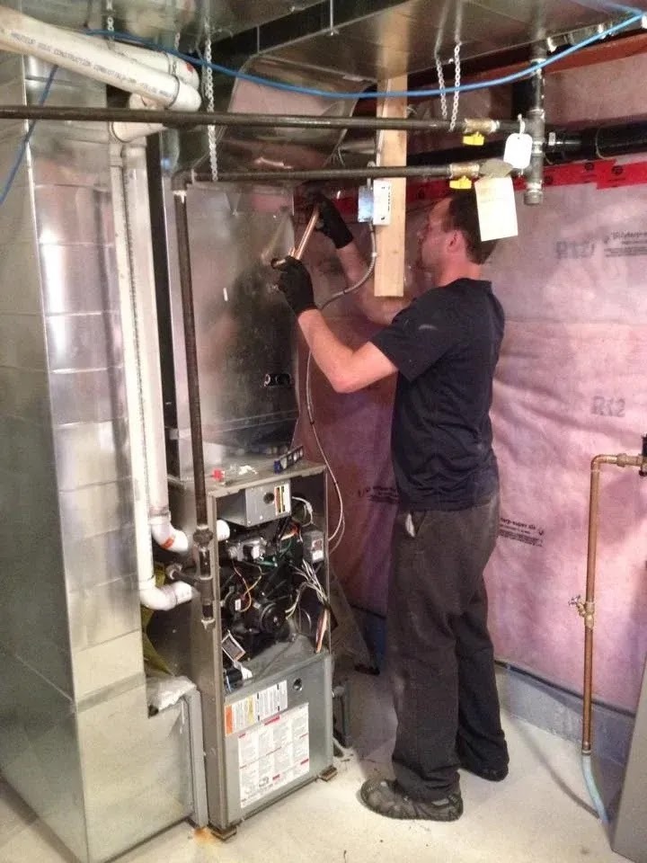 Technician performing regular maintenance on HVAC ductwork, ensuring optimal performance