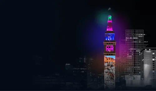Daniels Fisher Tower with colorful light at night.