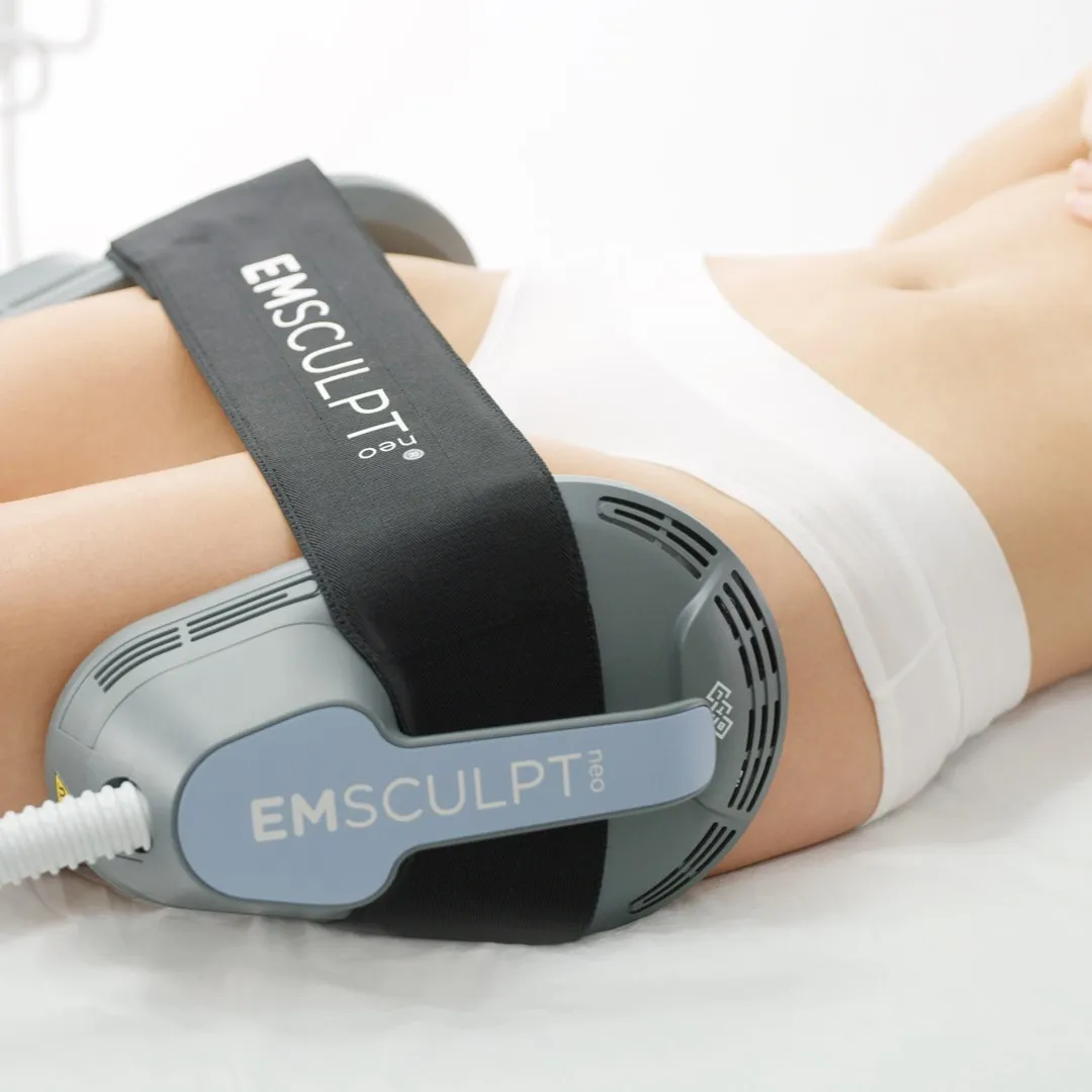 A woman using the Emsculpt Neo device