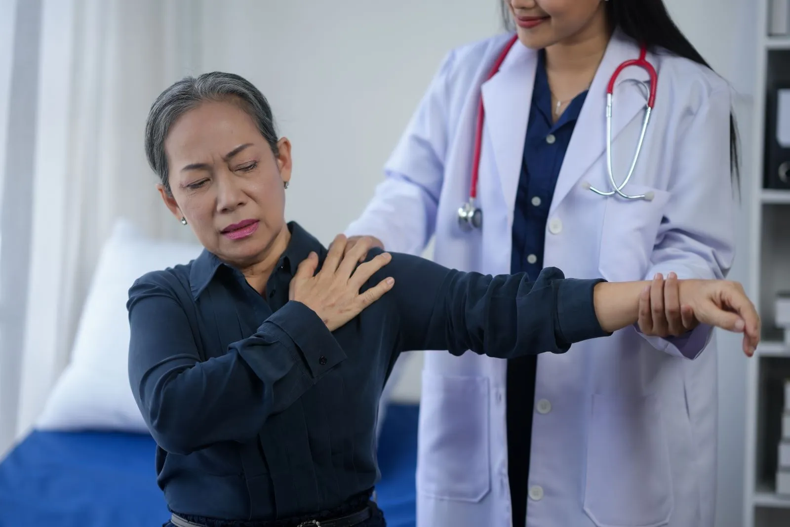 A doctor checking out a patients arm