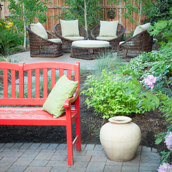 Two outdoor seating areas in a beautiful garden area