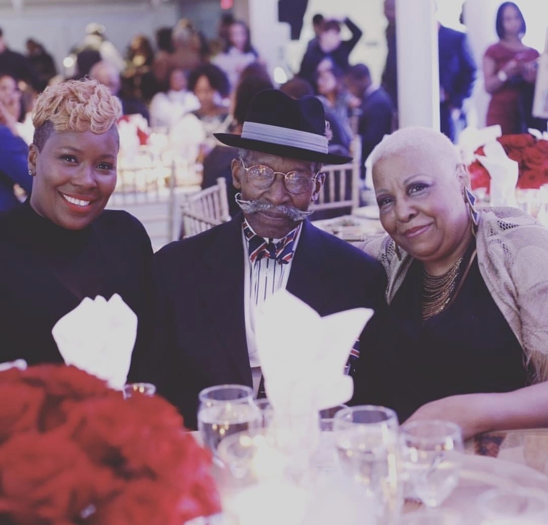 Dr. Topeka K Sam with mother and father at dinner