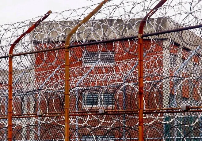 Barbed wire fence around prison