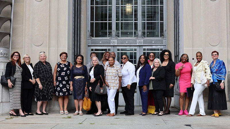 Alt text: Justice-impacted women and advocates gathered outside the U.S. Department of Justice for The LOHM's #RemissionNow action