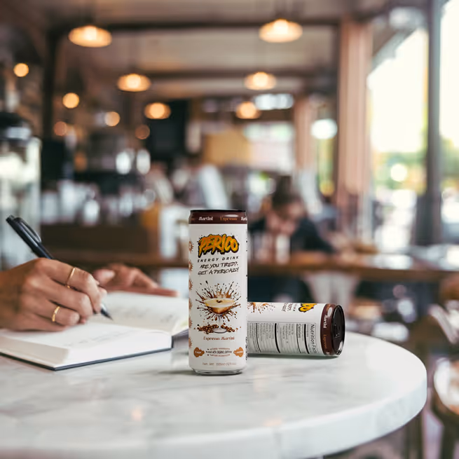 Perico Espresso Martini energy drink on a café table beside an open notebook, symbolizing mental clarity and focus for students. Perfect for staying sharp through study sessions, from first period to finals, this caffeine-powered beverage supports brain function without added sugar. 