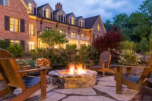 Elegant country estate surrounded by greenery, representing the retreat location.