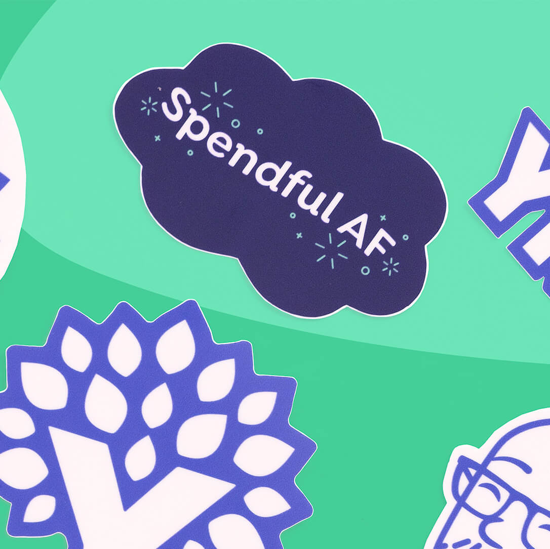 YNAB vinyl sticker shaped like a cloud that reads “Spendful AF,” displayed among other YNAB stickers on a teal background.