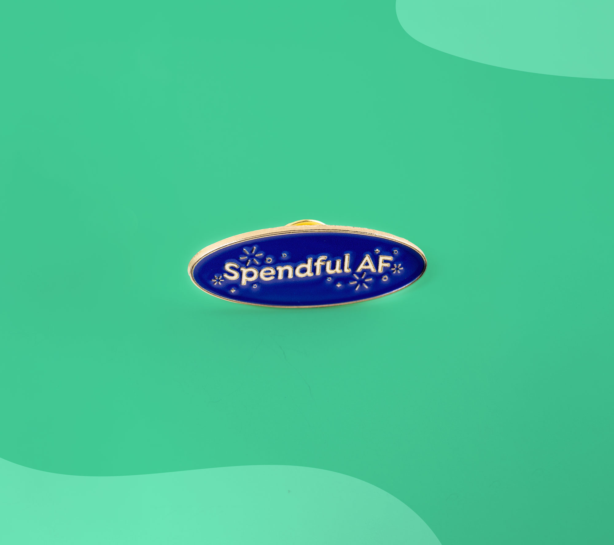 YNAB enamel pin reading “Spendful AF” displayed on a teal background.