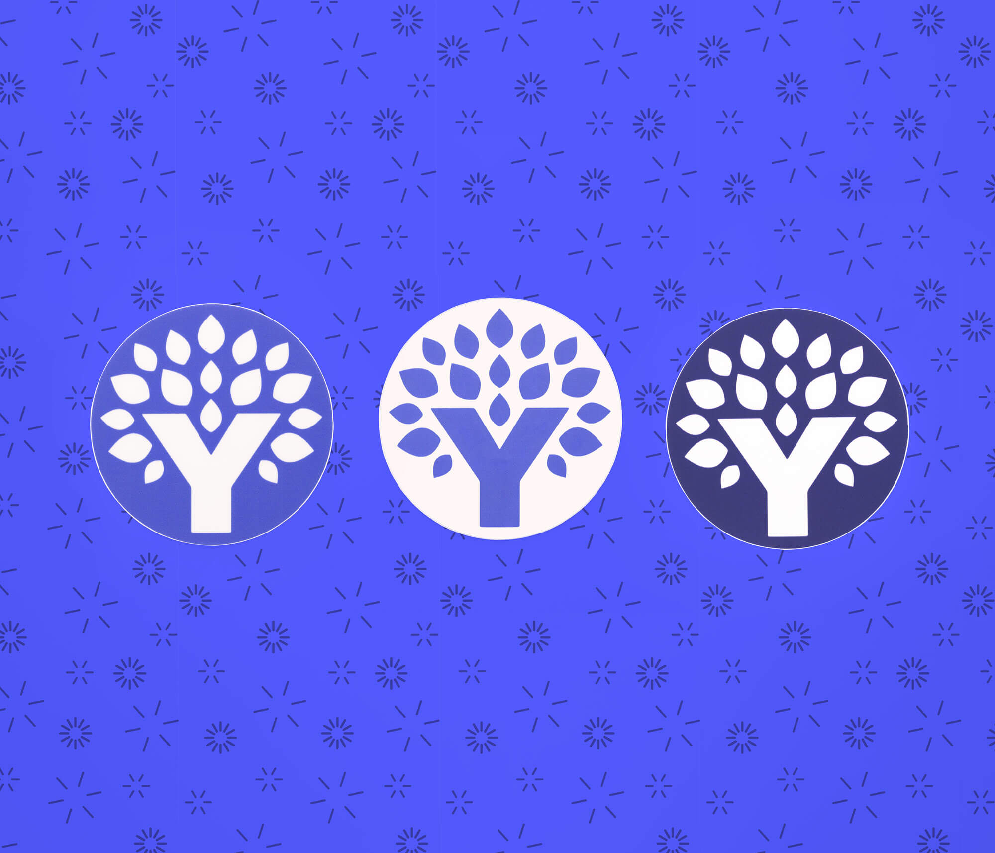 Three round YNAB Tree stickers in shades of blue displayed on a patterned blue background.