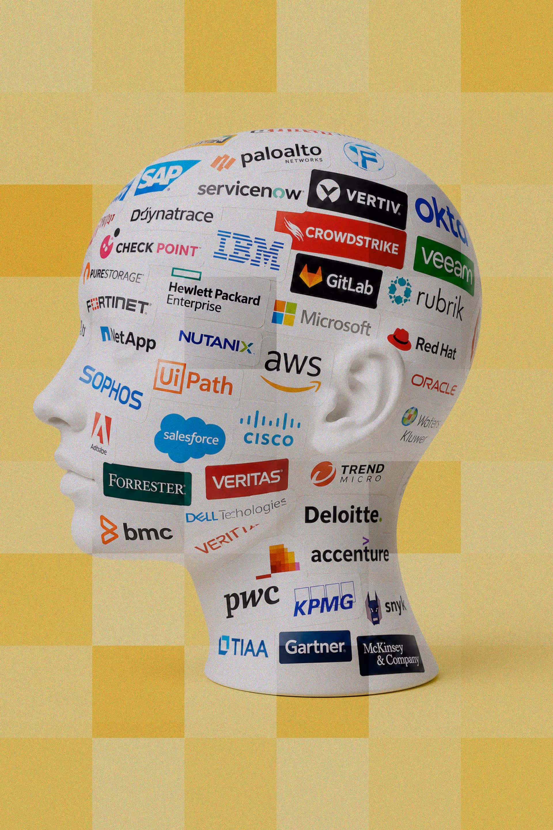 Mannequin head covered with stickers of well-known B2B and enterprise technology brands on a yellow background.