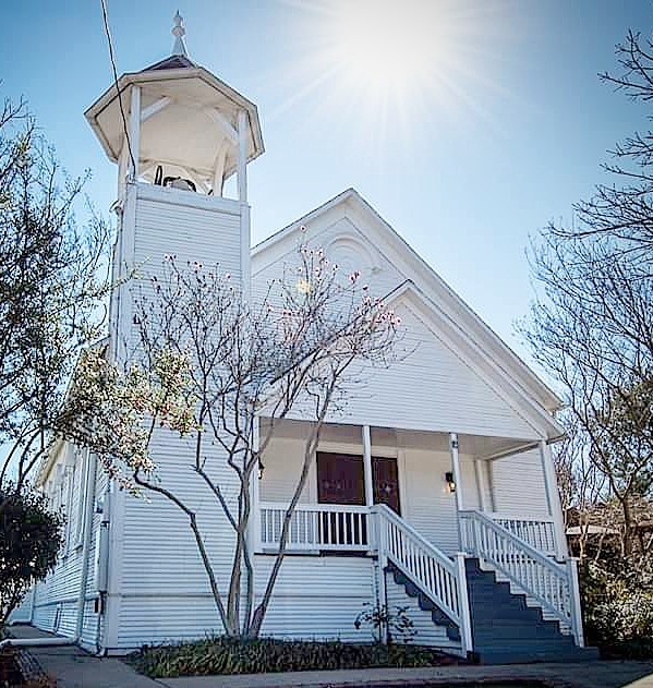 Exterior photo of a white historic chapel