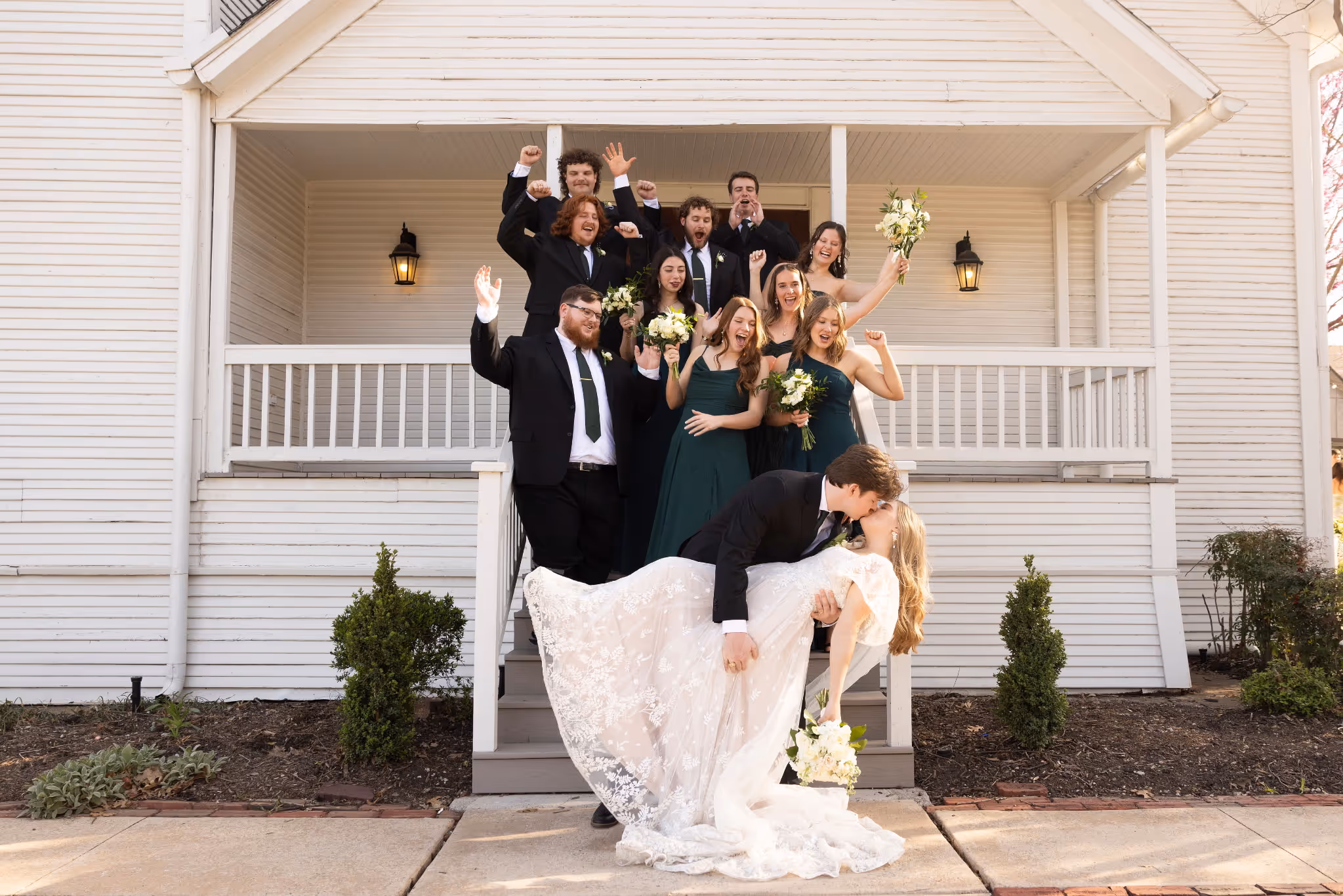 Wedding party celebrating on the steps of the historic chapel