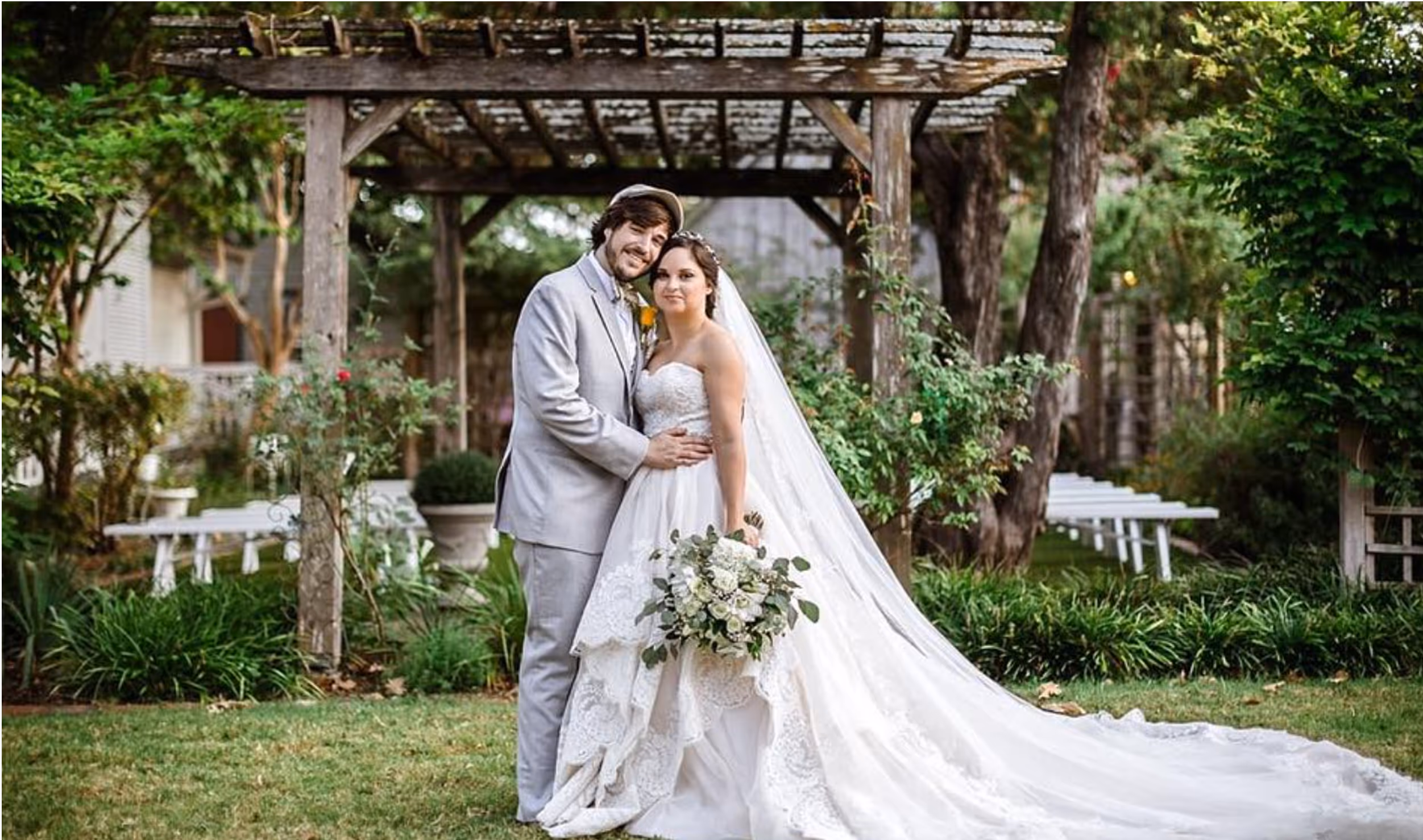 Smiling couple outside in the wedding garden