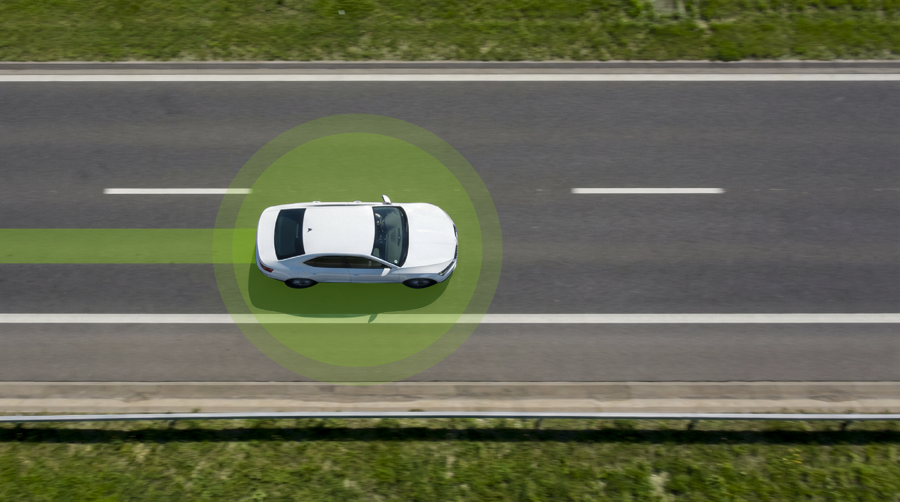 Aerial view of a white car on a road with a green GPS tracker location signal overlay illustrating real-time vehicle tracking
