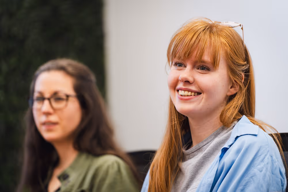 Employees smiling in a meeting
