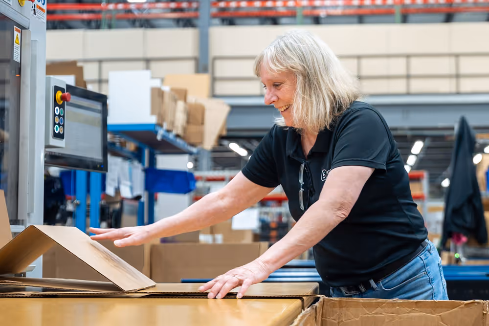 Fulfillment employee making custom boxes