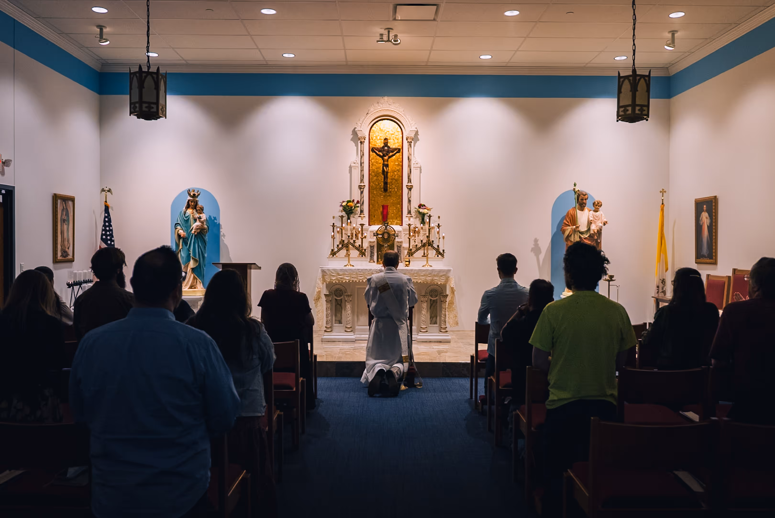 Team praying in the chapel in front of the Eucharist