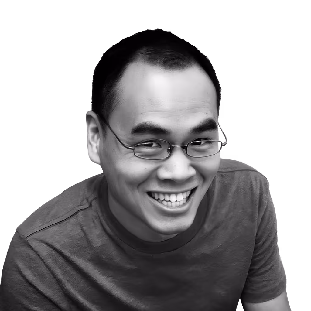 Smiling man with glasses wearing a casual t-shirt looking at the camera.