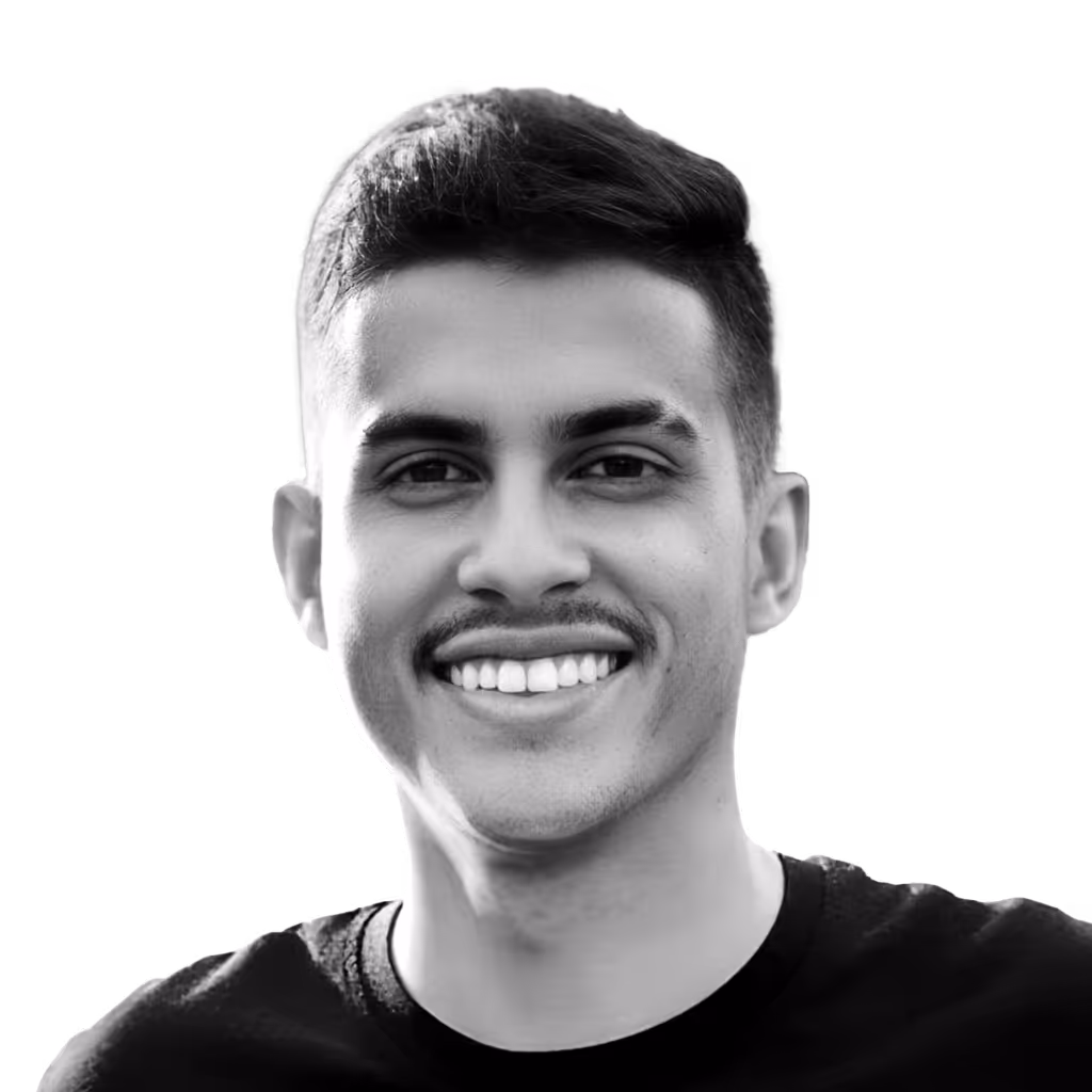 Smiling young man with short hair and mustache wearing a black shirt on a transparent background.