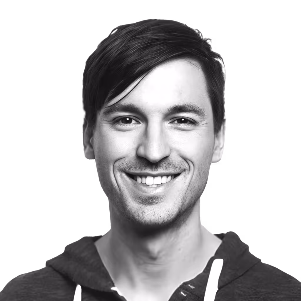 Smiling young man with short dark hair wearing a hoodie.