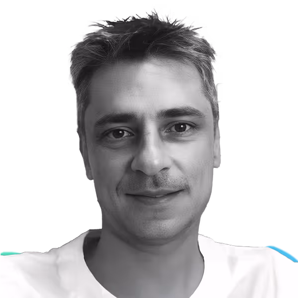 Smiling man with short, slightly tousled hair wearing a white shirt against a transparent background.