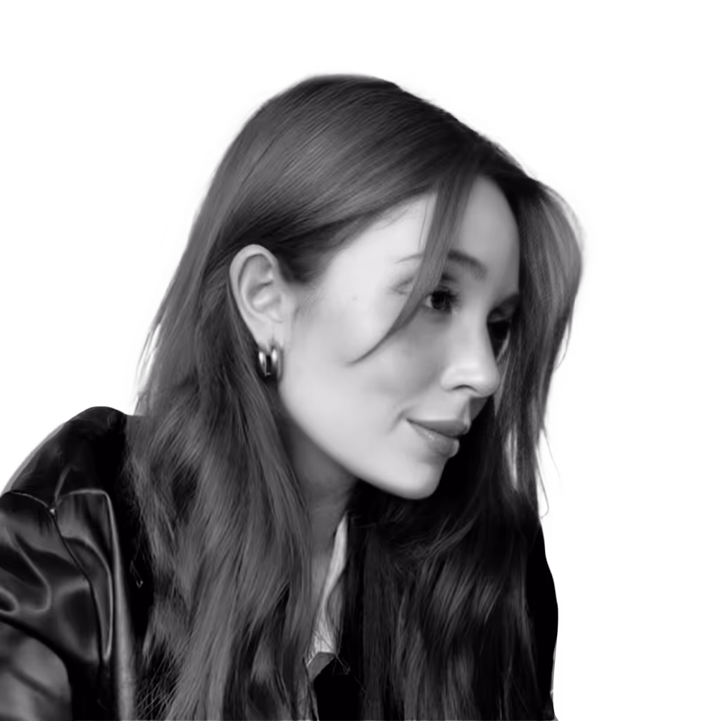 Black and white portrait of a young woman with long hair looking to the side, wearing hoop earrings and a leather jacket.