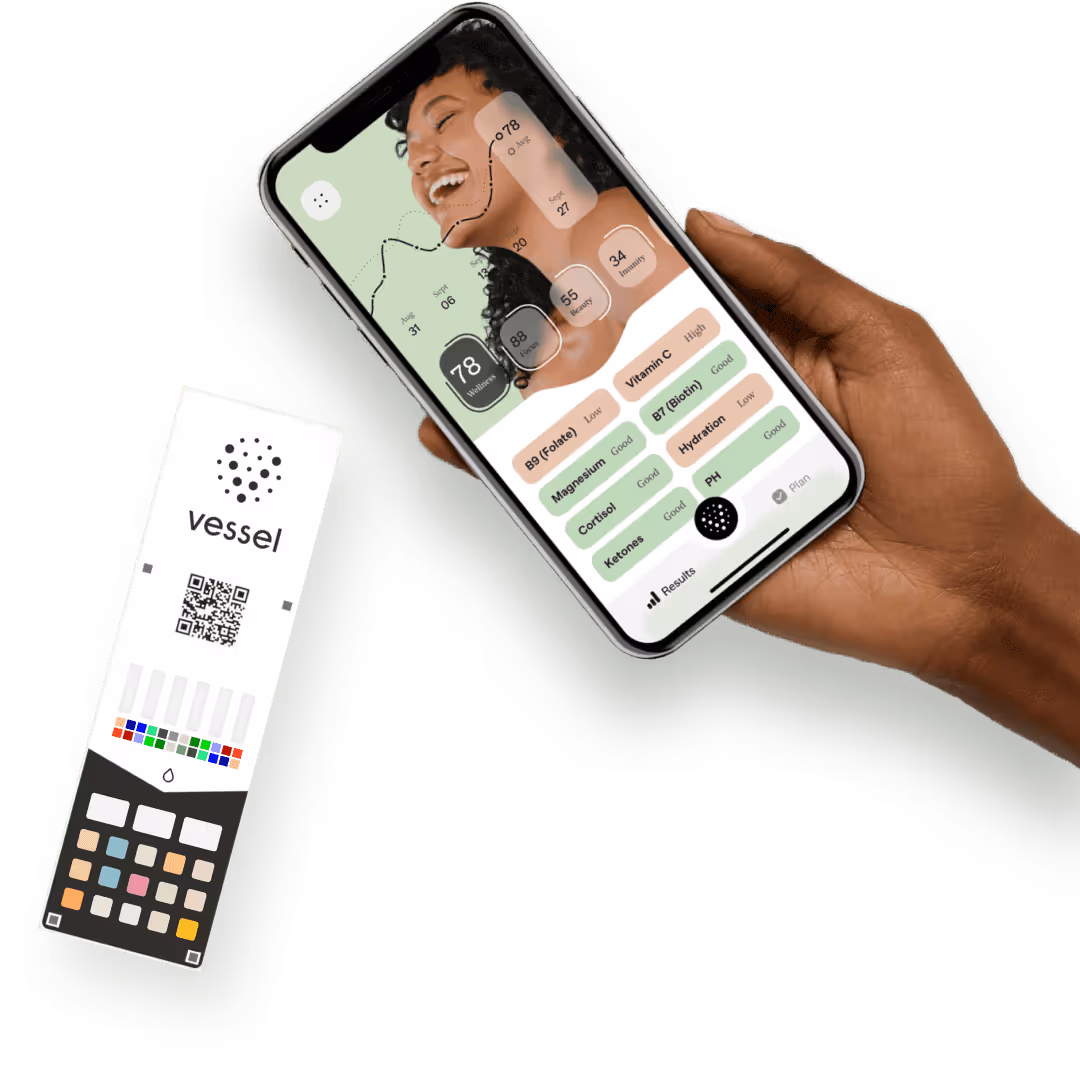 Hand holding a smartphone displaying a health app with wellness, focus, energy, and immunity scores alongside nutrient and hydration levels; a Vessel health test strip with colored squares and a QR code is next to the hand.