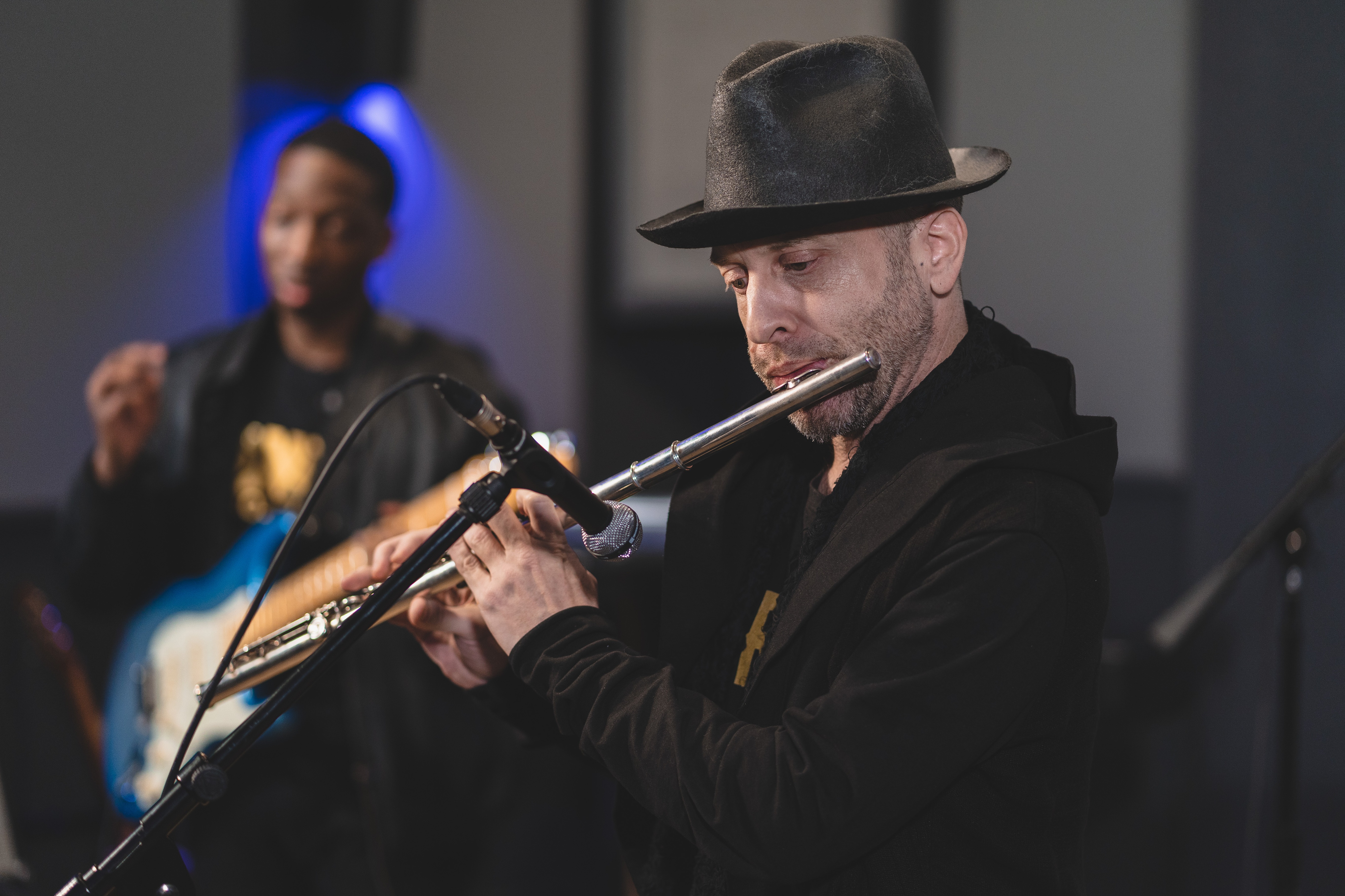 Musicians in control room watching performance at DNA Project showcase