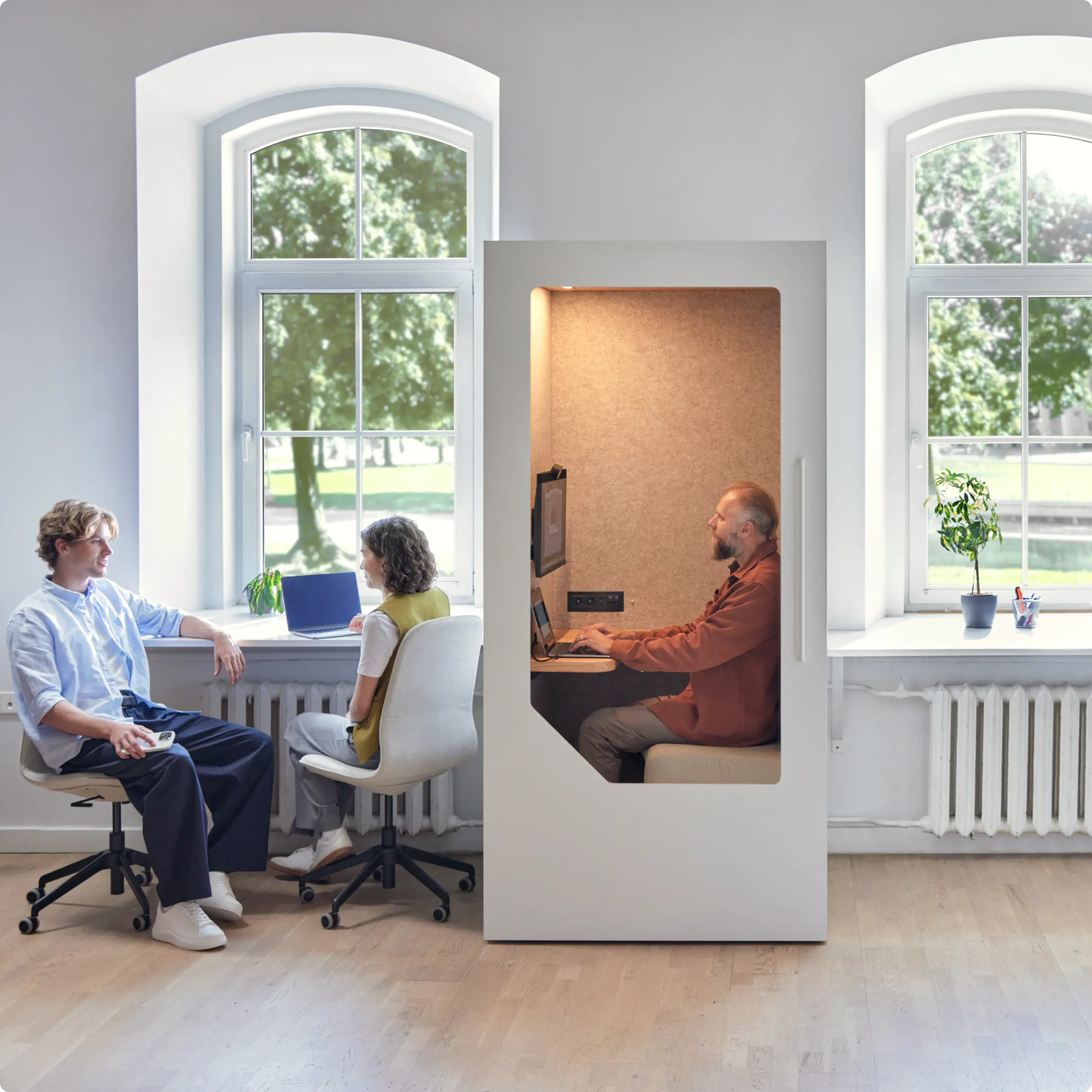 Person working inside a Persy Booth with fresh air ventilation while colleagues sit outside