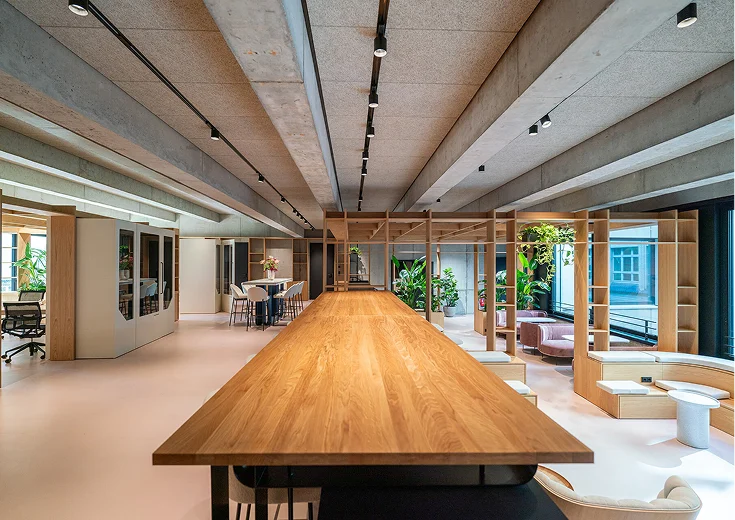 Persy Booths team standing in front of a bright yellow soundproof office pod