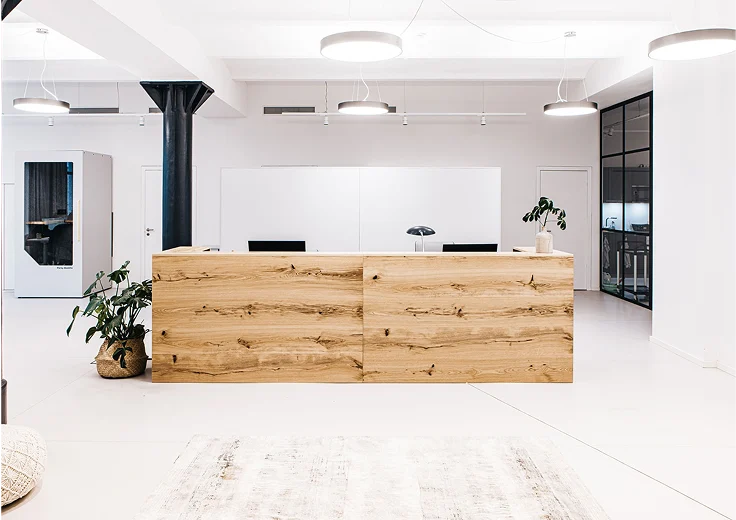 Persy Booths team standing in front of a bright yellow soundproof office pod