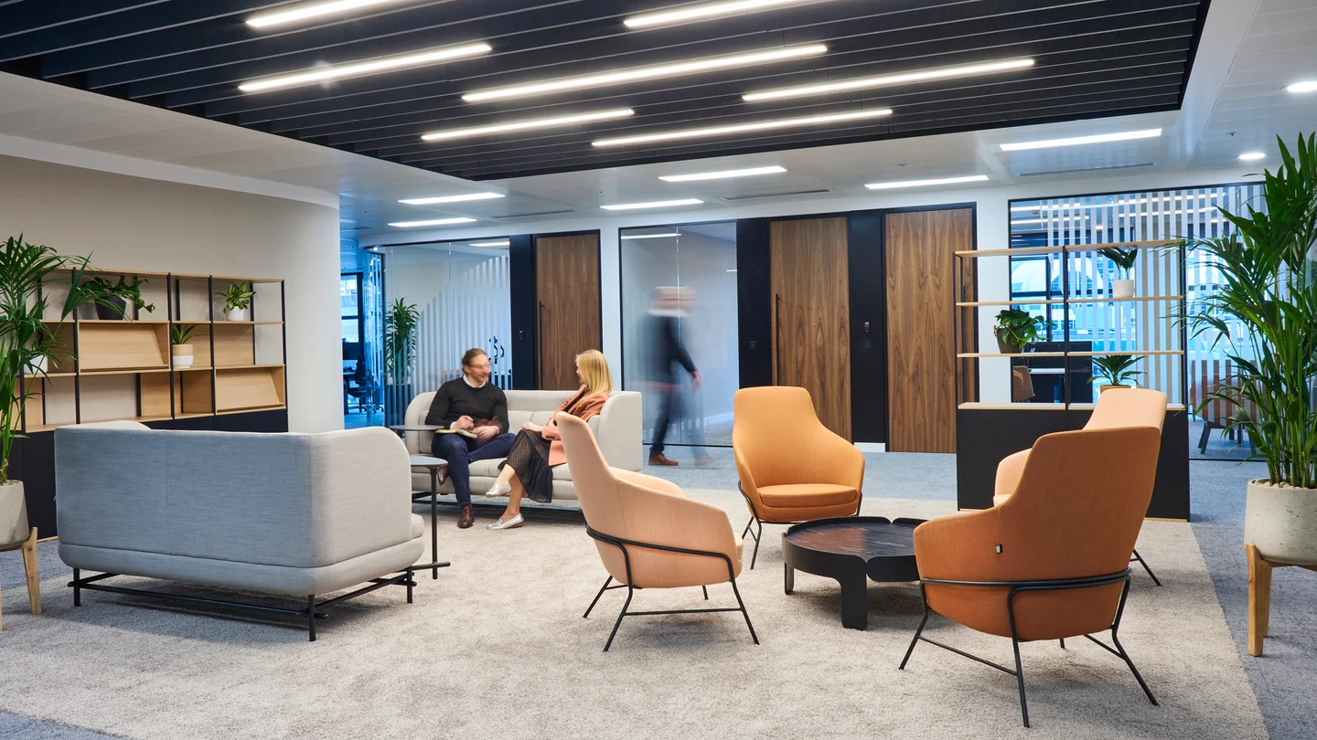 Two People Are Talking In Collaborative Workspace