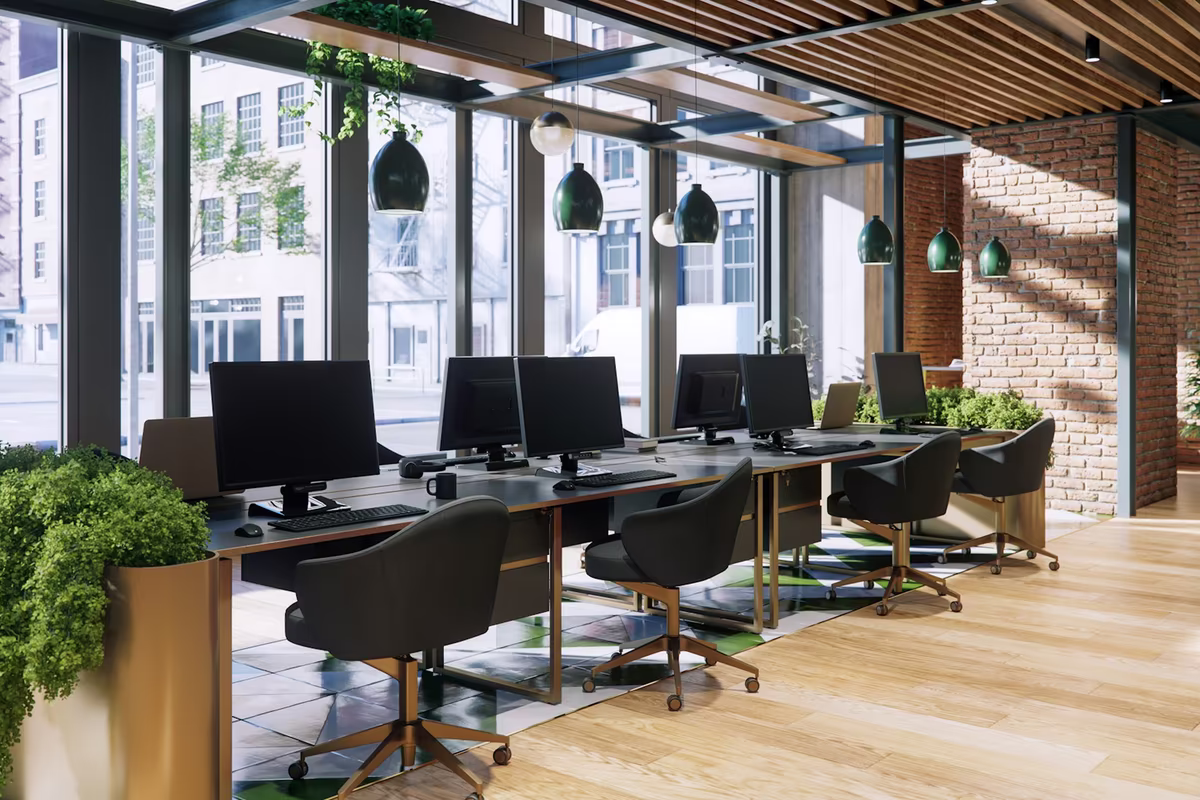 Open plan office workspace with multiple desks and shared work areas