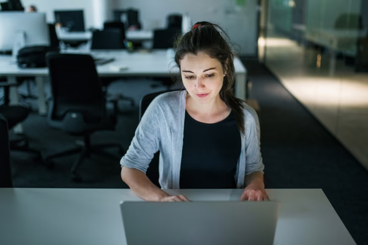 Employee working on a laptop in a quiet office focus area intended for concentrated individual work