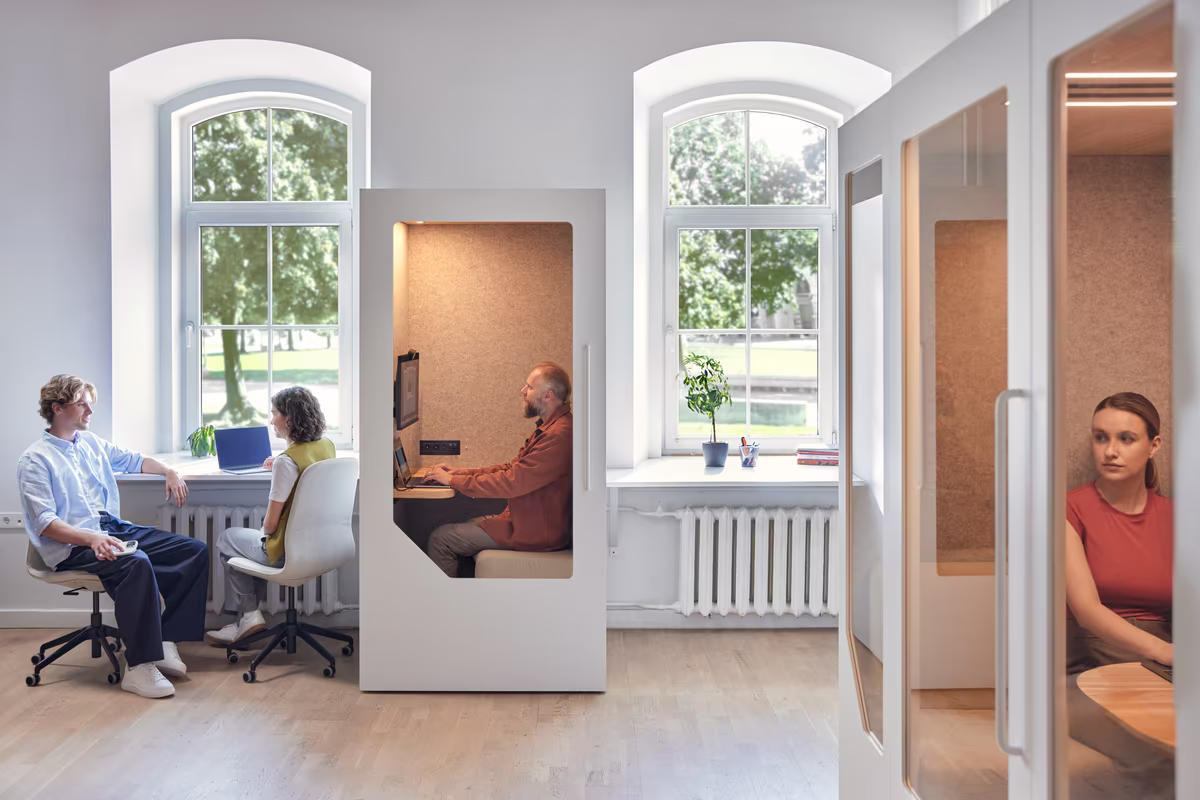 Office pods used for calls and work within a shared workspace layout