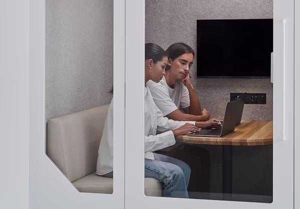 Team using an office pod designed for collaboration and focused work