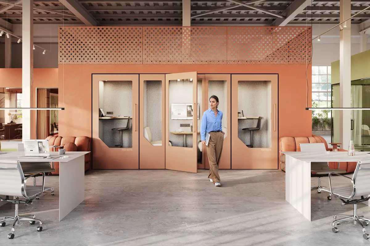 person working focused inside a soundproof office pod